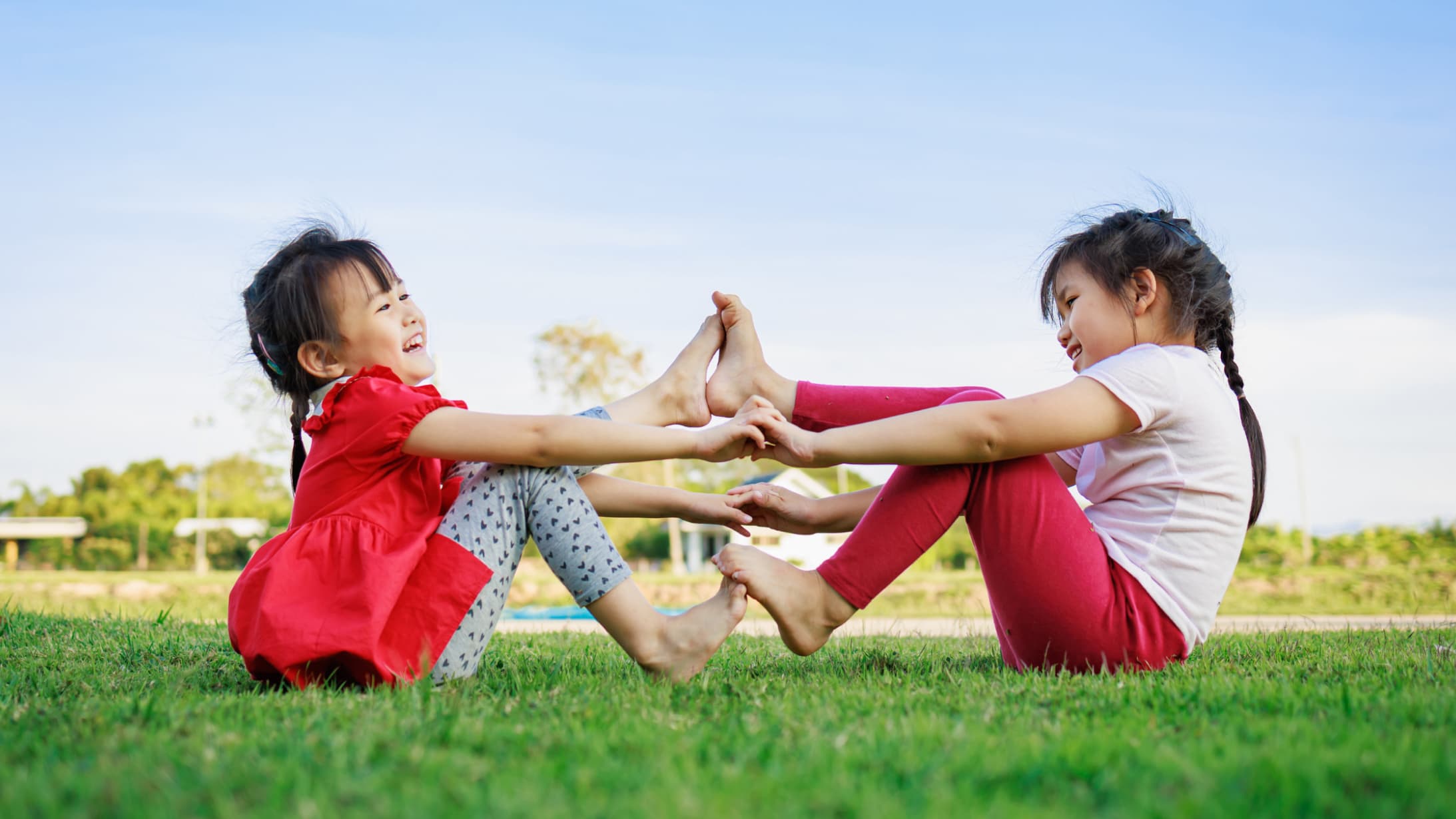 two kids playing on grass