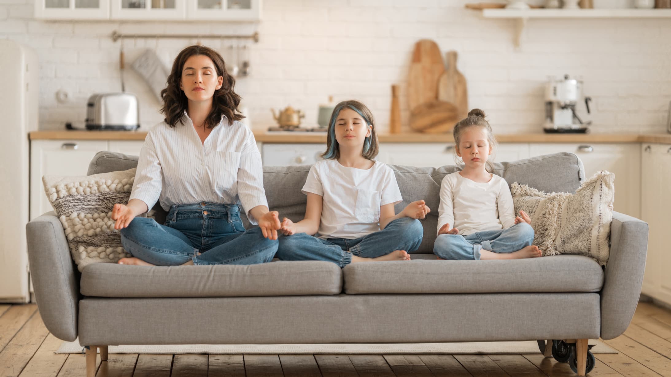 family sitting on couch meditating